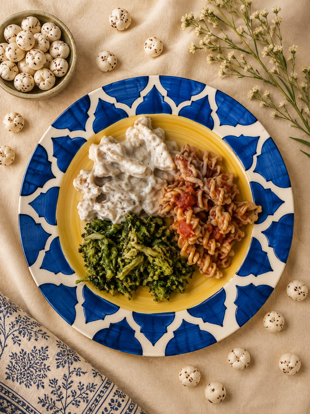 Trio of pasta with pesto, alfredo and pomodoro on a blue and yellow ceramic plate